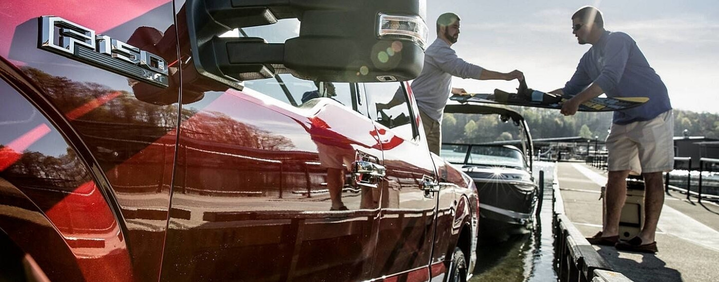 Red 2018 Ford F-150 XLT parked at a pier